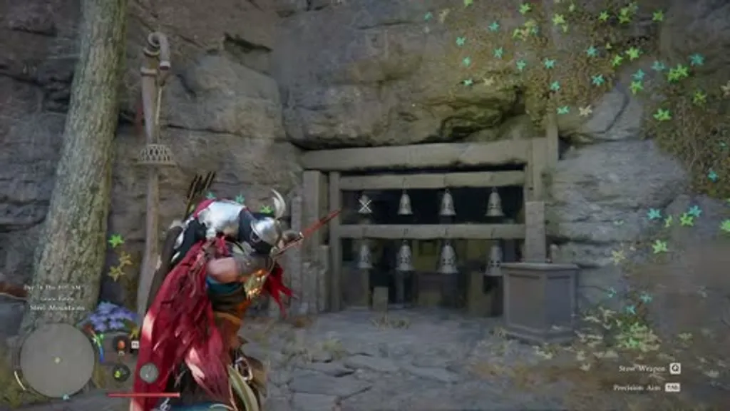 The Steel Mountains bell puzzle shrine in Crimson Desert, showing a row of six hanging bronze bells with F and P symbol engravings mounted in a stone alcove in a cave wall, with the player character aiming a bow at the bells and green leaf particles floating in the air.
